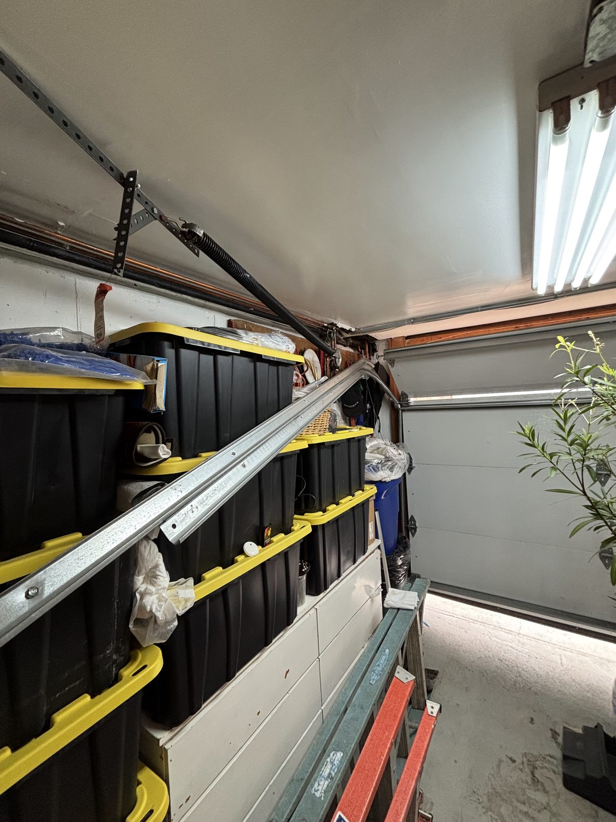Damaged garage door track removed during a repair